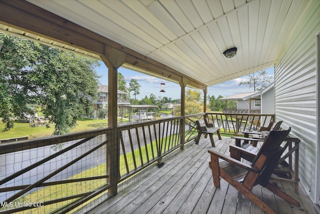 10167 Lagan St, Bay Saint Louis, MS 39520 - wooden deck featuring a lawn