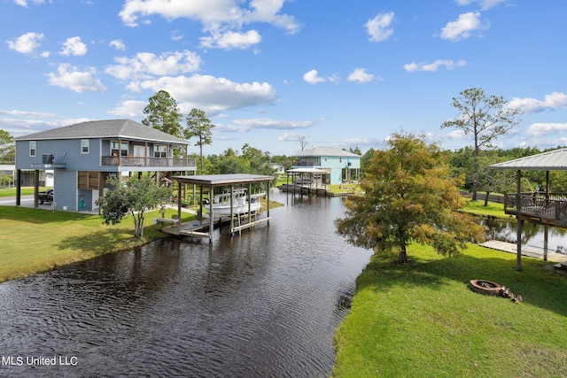 view of dock featuring a lawn, a water view, and a fire pit