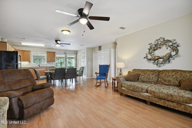 10167 Lagan St, Bay Saint Louis, MS 39520 - living room with ceiling fan, light wood-style floors, and baseboards