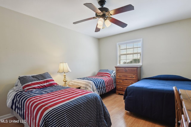 bedroom with light hardwood / wood-style flooring and ceiling fan