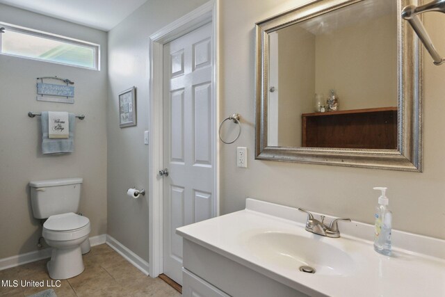 bathroom featuring vanity, toilet, and tile patterned flooring