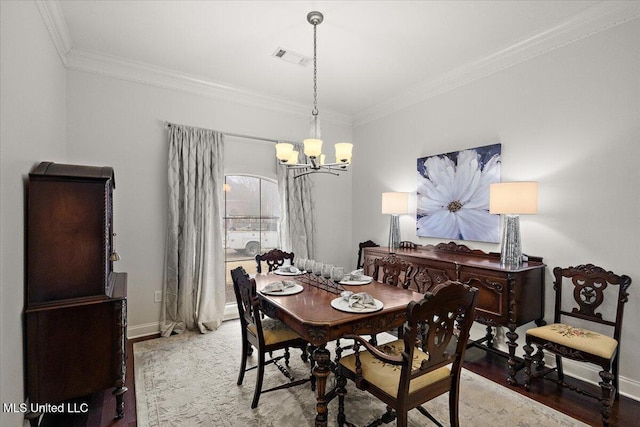 dining space featuring crown molding, hardwood / wood-style floors, and a notable chandelier