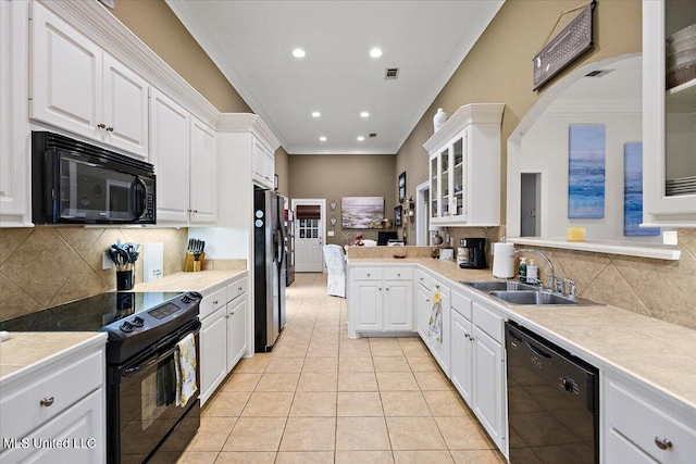 kitchen with crown molding, white cabinets, sink, and black appliances