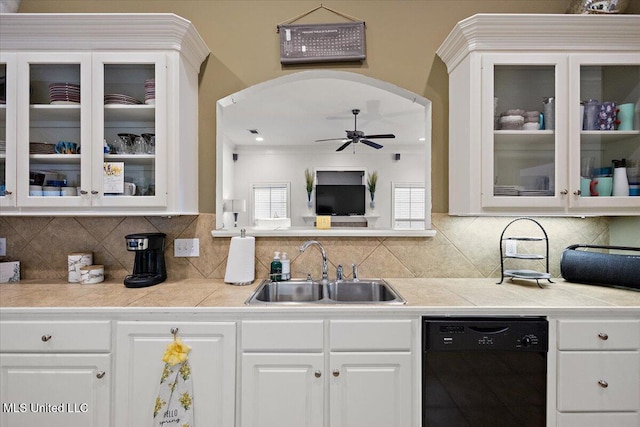 kitchen featuring sink, ceiling fan, backsplash, black dishwasher, and white cabinets