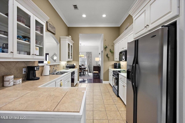 kitchen featuring light tile patterned flooring, sink, white cabinets, and black appliances