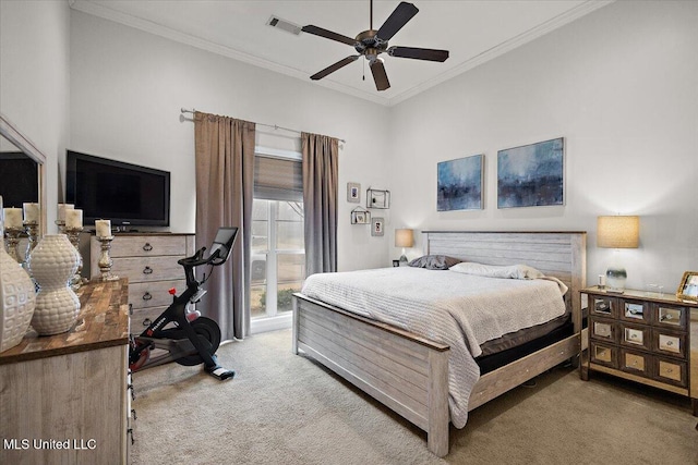 carpeted bedroom featuring ceiling fan and ornamental molding