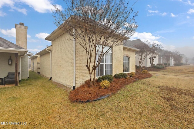 view of side of home featuring a lawn