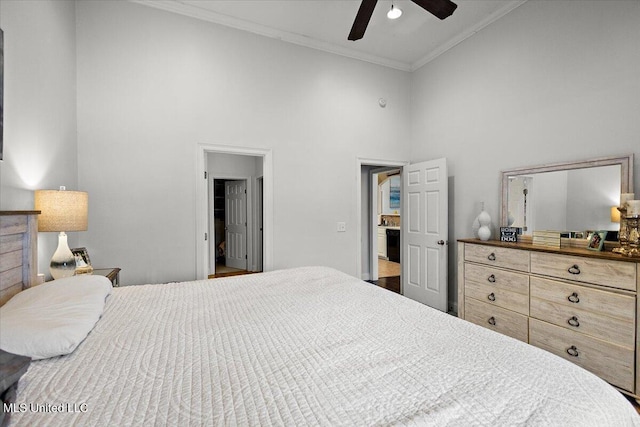 bedroom featuring crown molding, ceiling fan, and a towering ceiling