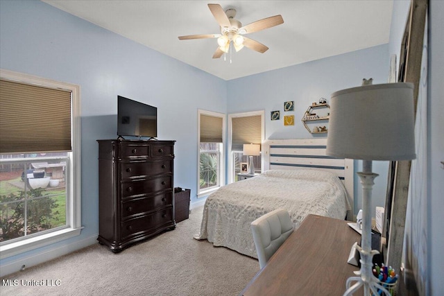 bedroom with ceiling fan and light carpet