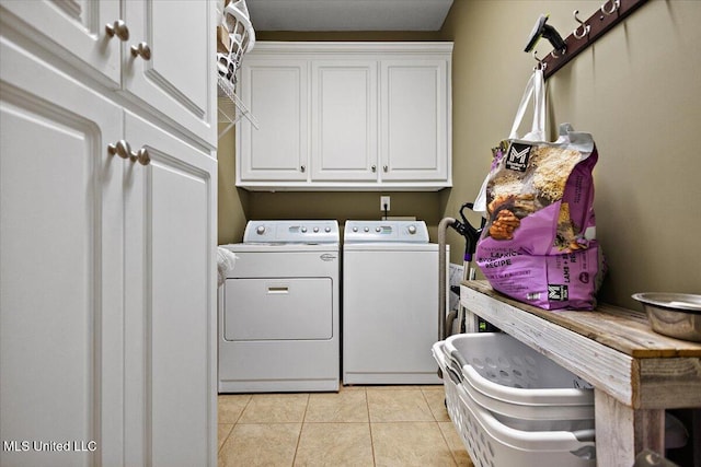 laundry area with cabinets, separate washer and dryer, and light tile patterned floors