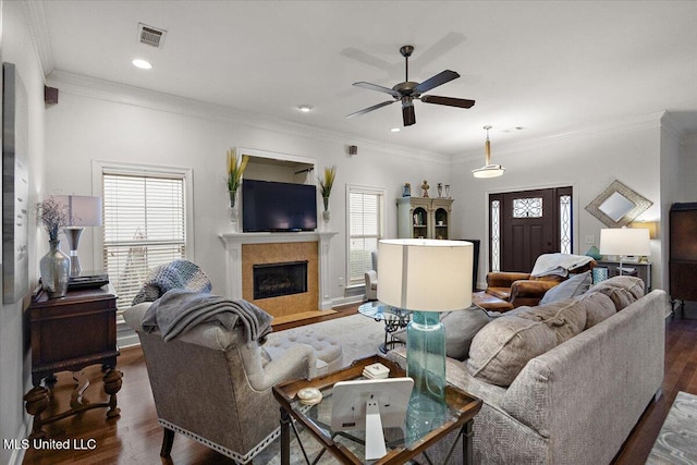 living room with plenty of natural light, dark hardwood / wood-style flooring, and a tiled fireplace