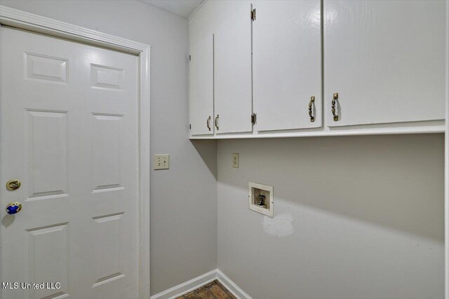clothes washing area with baseboards, cabinet space, and hookup for a washing machine