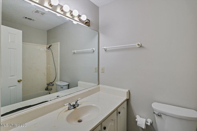 full bath featuring toilet, visible vents, bathtub / shower combination, and vanity