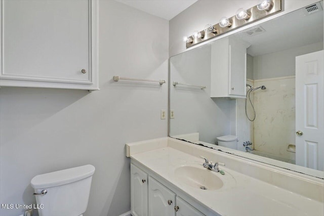 full bathroom with vanity, toilet, a shower, and visible vents