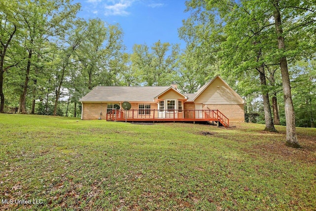 view of front of home featuring a chimney, a deck, and a front yard