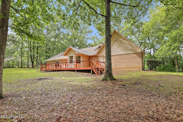 back of house with a wooden deck and a yard