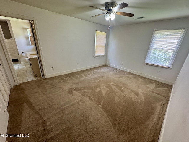 221 S Oak Ave, Ruleville, MS 38771 - unfurnished room featuring ceiling fan and light carpet