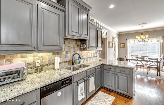 kitchen with crown molding, gray cabinets, stainless steel dishwasher, a notable chandelier, and a sink