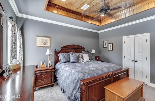 bedroom featuring visible vents, light colored carpet, wood ceiling, and a raised ceiling