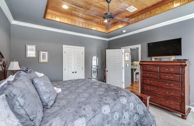 bedroom with a ceiling fan, visible vents, a tray ceiling, wood ceiling, and crown molding