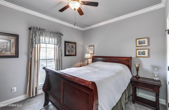 bedroom featuring ceiling fan, crown molding, baseboards, and carpet floors