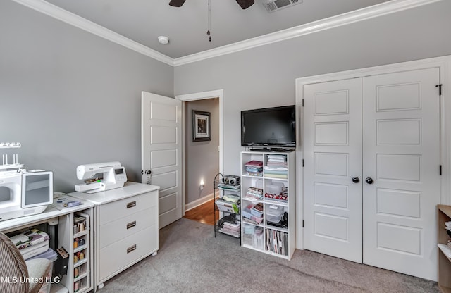 office space featuring baseboards, visible vents, ceiling fan, light carpet, and crown molding