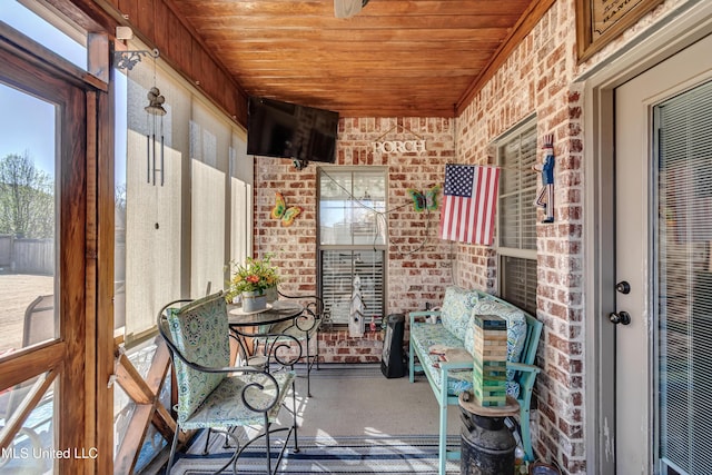 unfurnished sunroom with wood ceiling