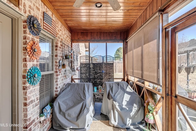 unfurnished sunroom with wooden ceiling and ceiling fan