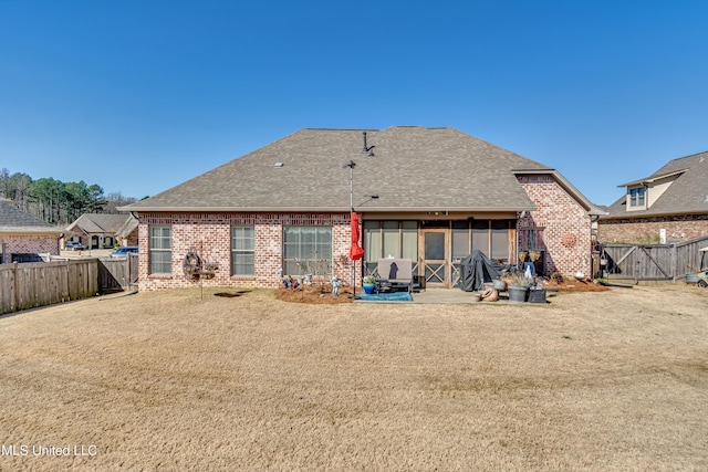 rear view of property with a patio, brick siding, and a shingled roof