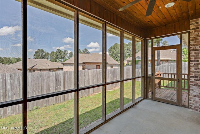 unfurnished sunroom with a ceiling fan