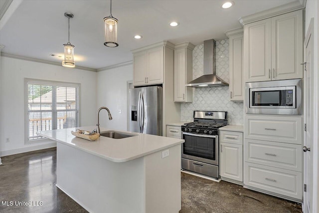 kitchen featuring wall chimney range hood, tasteful backsplash, light countertops, a sink, and stainless steel appliances