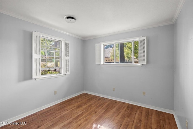 unfurnished room featuring hardwood / wood-style flooring and crown molding