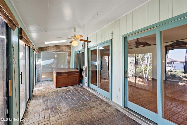 unfurnished sunroom featuring ceiling fan and lofted ceiling