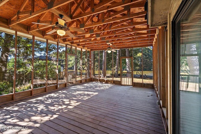 unfurnished sunroom featuring ceiling fan and plenty of natural light