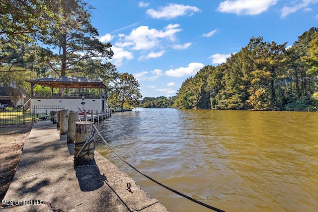 view of dock with a gazebo and a water view