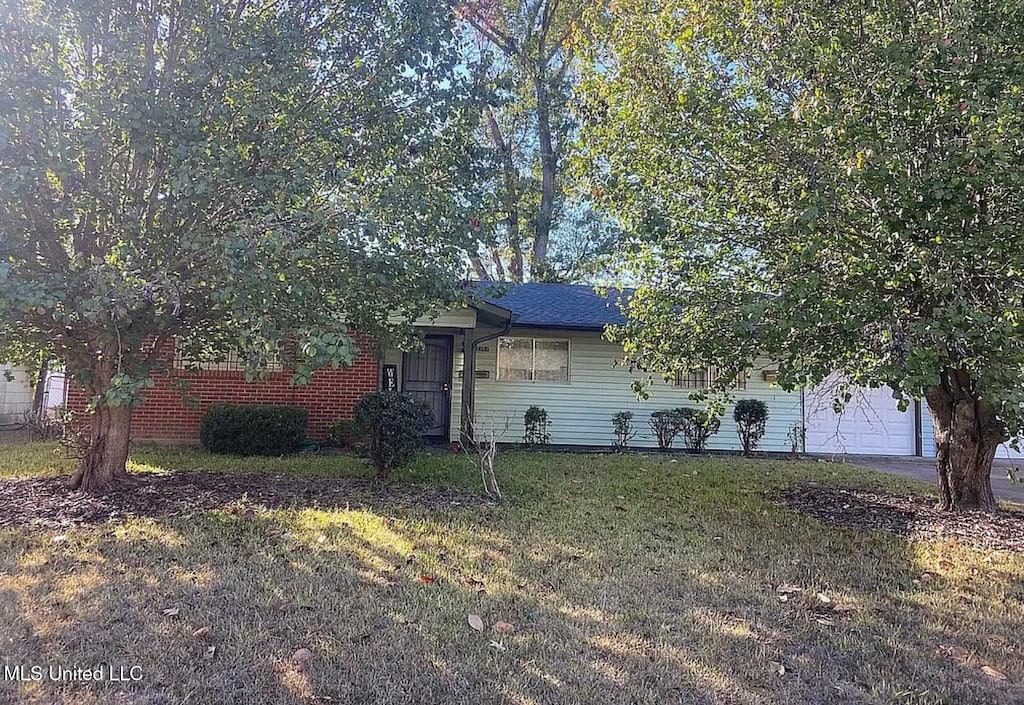 3384 Casa Grande Cir, Jackson, MS 39209 - view of front of property with a front lawn and a garage