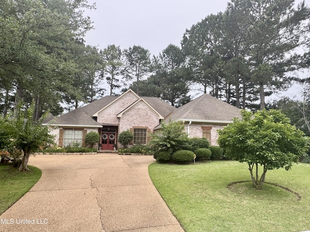 856 Wellington Way, Madison, MS 39110 - view of front facade with a front lawn, a shingled roof, brick siding, and driveway