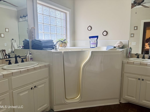 856 Wellington Way, Madison, MS 39110 - ensuite bathroom featuring a ceiling fan, two vanities, ornamental molding, and a tub
