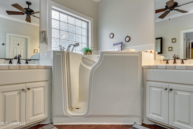 856 Wellington Way, Madison, MS 39110 - bathroom featuring ceiling fan, two vanities, ornamental molding, and wood finished floors