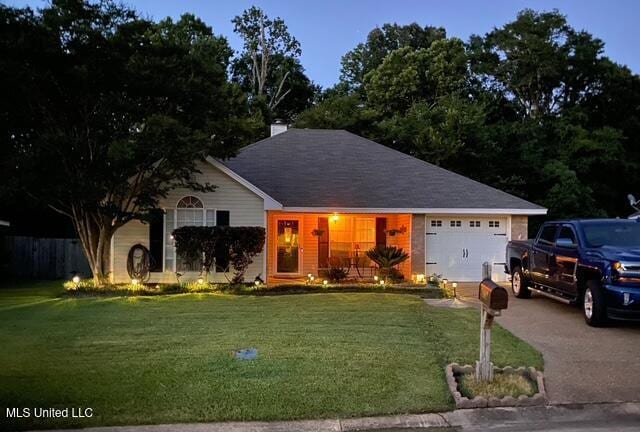 4328 Blaine Cir, Byram, MS 39272 - ranch-style house featuring a garage, asphalt driveway, and a front lawn