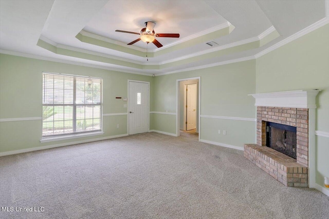 4328 Blaine Cir, Byram, MS 39272 - unfurnished living room featuring a tray ceiling, a ceiling fan, carpet flooring, ornamental molding, and a fireplace