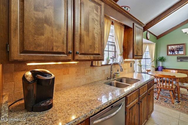 kitchen with vaulted ceiling with beams, tasteful backsplash, a sink, light stone countertops, and dishwasher