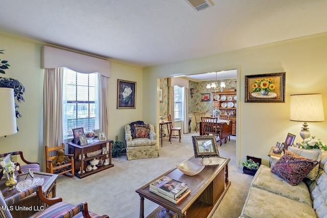 living area with crown molding, carpet flooring, plenty of natural light, and visible vents