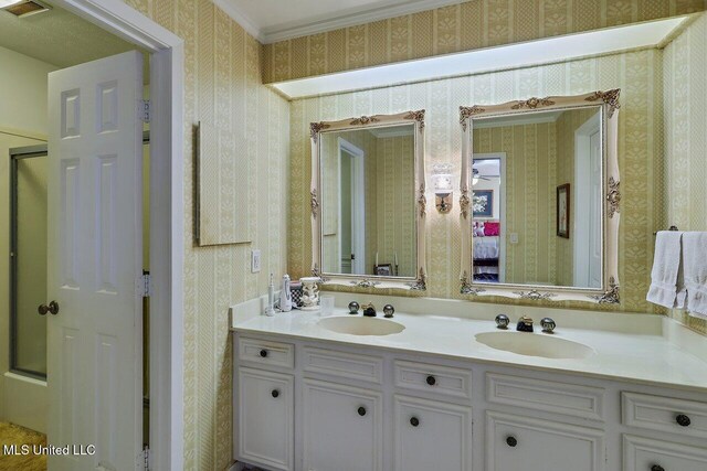 bathroom with wallpapered walls, visible vents, and a sink