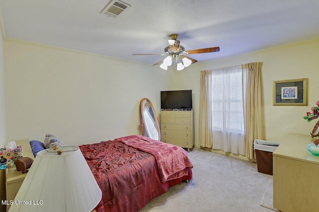 bedroom featuring light carpet, ceiling fan, visible vents, and crown molding