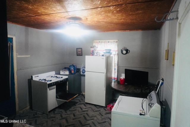 clothes washing area with washer / clothes dryer and wooden ceiling