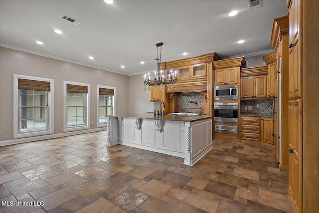 12025 Springridge Rd, Terry, MS 39170 - kitchen featuring appliances with stainless steel finishes, crown molding, backsplash, recessed lighting, and a center island with sink