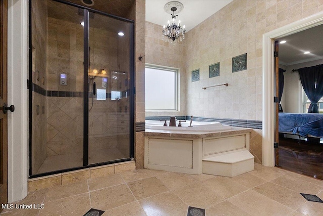 12025 Springridge Rd, Terry, MS 39170 - full bath with tile walls, a stall shower, a garden tub, ensuite bathroom, and a chandelier