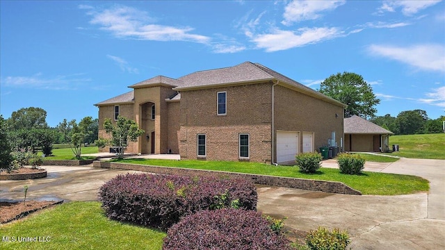 12025 Springridge Rd, Terry, MS 39170 - view of front of home featuring concrete driveway, a front lawn, and an attached garage