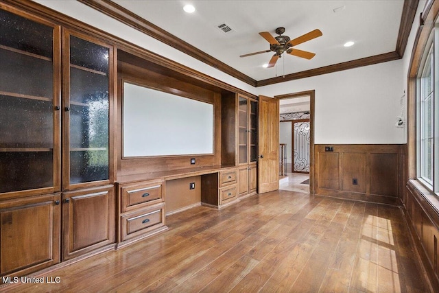 12025 Springridge Rd, Terry, MS 39170 - cinema featuring built in desk, a ceiling fan, ornamental molding, wood finished floors, and a wainscoted wall